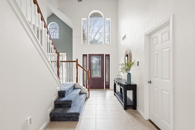 entrance foyer with a high ceiling and light tile patterned flooring