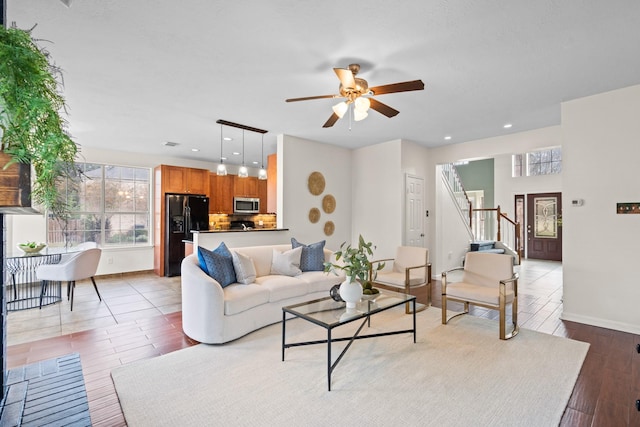 living room featuring ceiling fan and light wood-type flooring