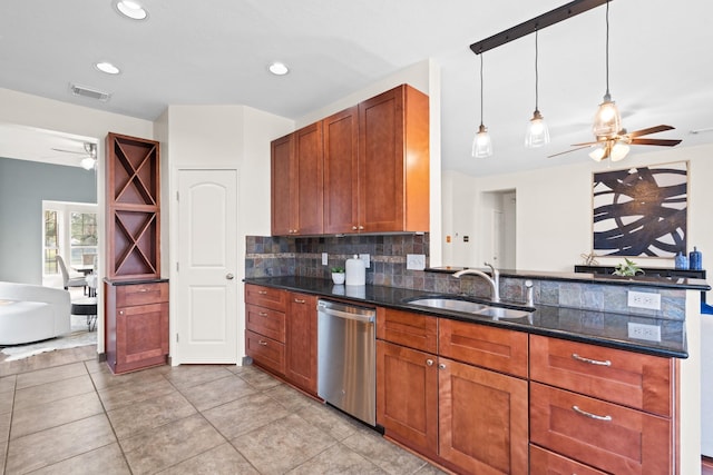 kitchen with tasteful backsplash, stainless steel dishwasher, sink, dark stone countertops, and hanging light fixtures