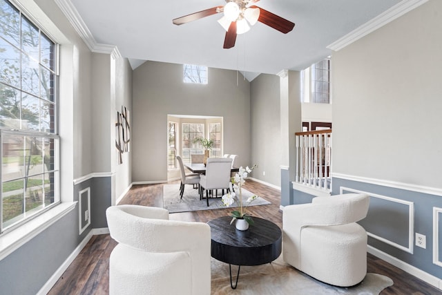 sitting room with a wealth of natural light, dark wood-type flooring, and ceiling fan