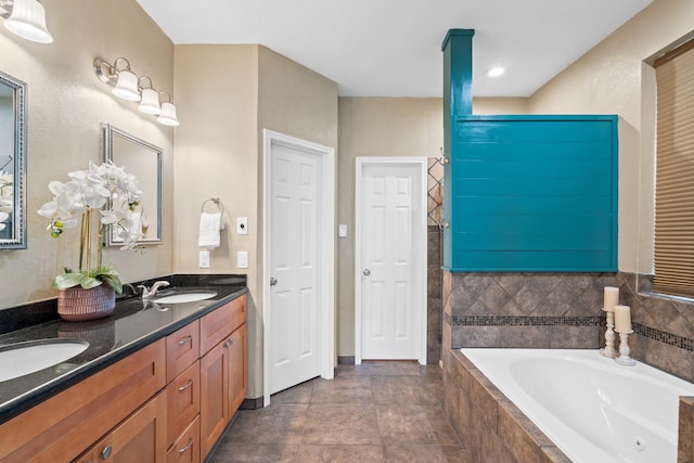 bathroom featuring vanity and tiled tub