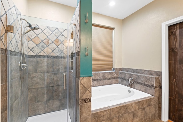 bathroom featuring separate shower and tub