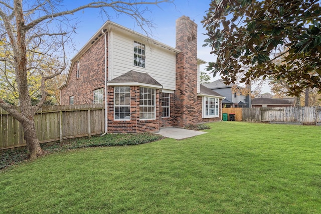 rear view of house featuring a yard