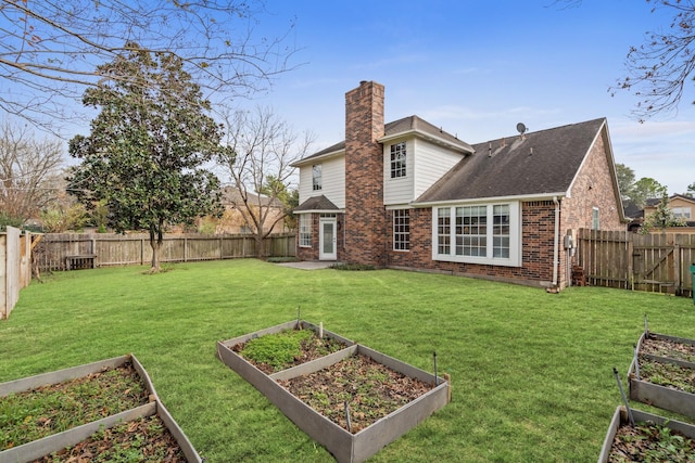 rear view of property with a yard