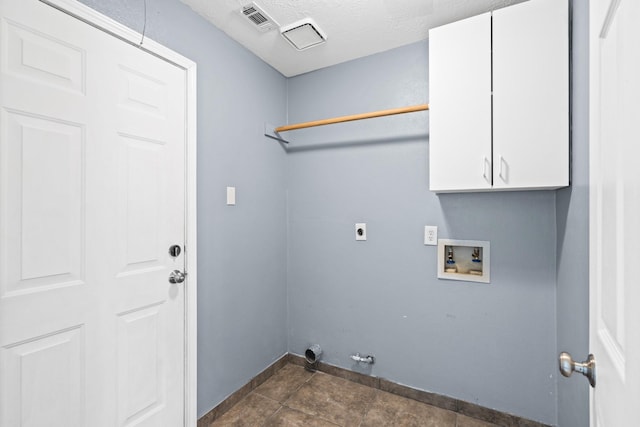 clothes washing area featuring cabinets, electric dryer hookup, hookup for a gas dryer, hookup for a washing machine, and a textured ceiling