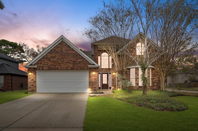 view of front property with a garage and a lawn