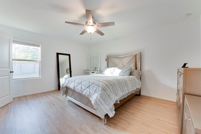 bedroom featuring light wood-type flooring and ceiling fan