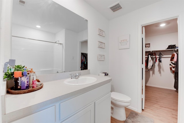 bathroom featuring hardwood / wood-style floors, vanity, and toilet