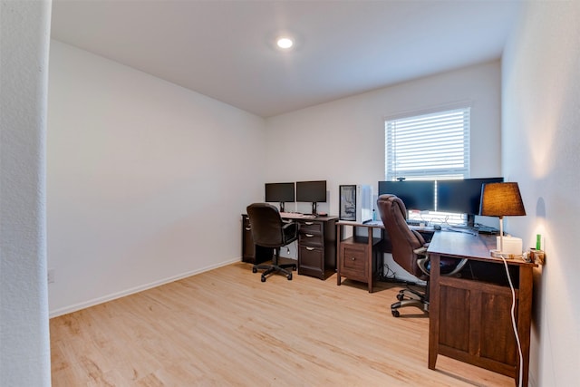 home office with light hardwood / wood-style floors