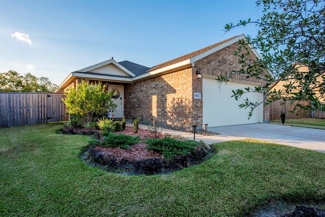 view of front of home with a front yard and a garage