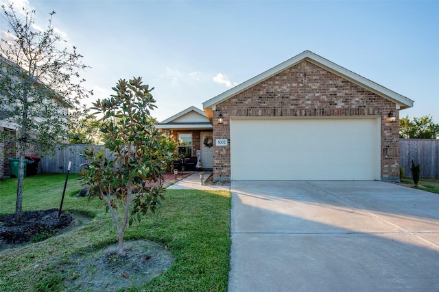 view of front of property featuring a garage and a front lawn