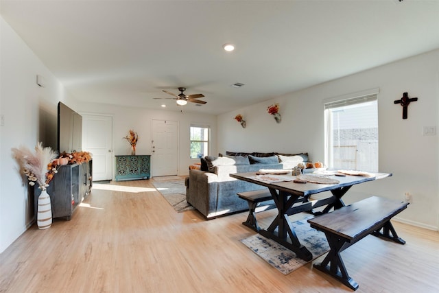 living room with light hardwood / wood-style flooring and ceiling fan