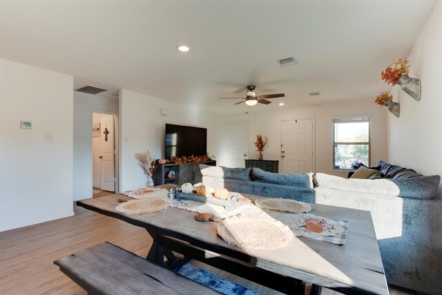 dining room featuring light hardwood / wood-style floors and ceiling fan