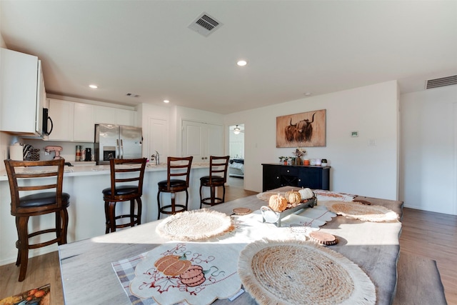 dining area featuring light wood-type flooring