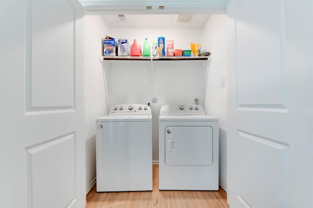 laundry area featuring light hardwood / wood-style floors and independent washer and dryer