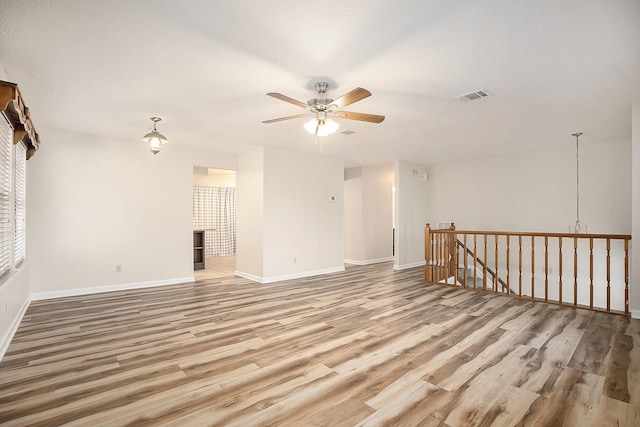 empty room with ceiling fan and wood-type flooring