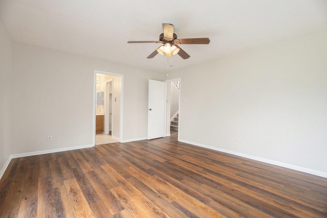 spare room featuring ceiling fan and dark wood-type flooring