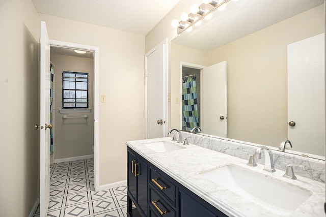 bathroom with a textured ceiling and vanity