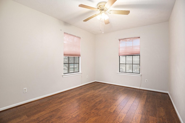 unfurnished room with dark hardwood / wood-style floors and ceiling fan