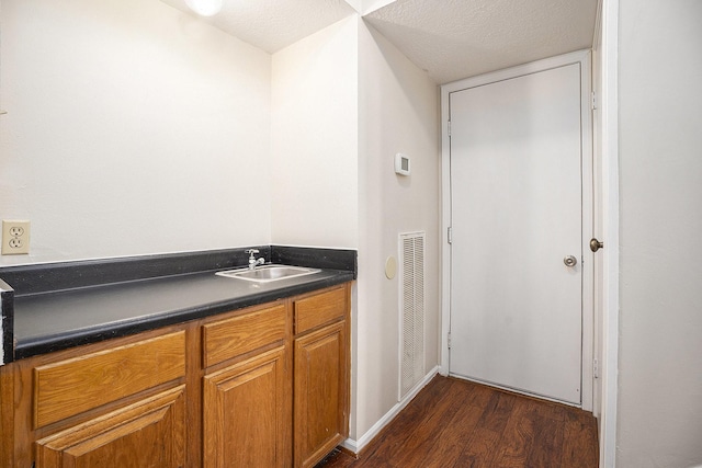 bathroom with vanity, a textured ceiling, and hardwood / wood-style flooring