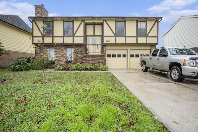 tudor-style house with a garage and a front yard