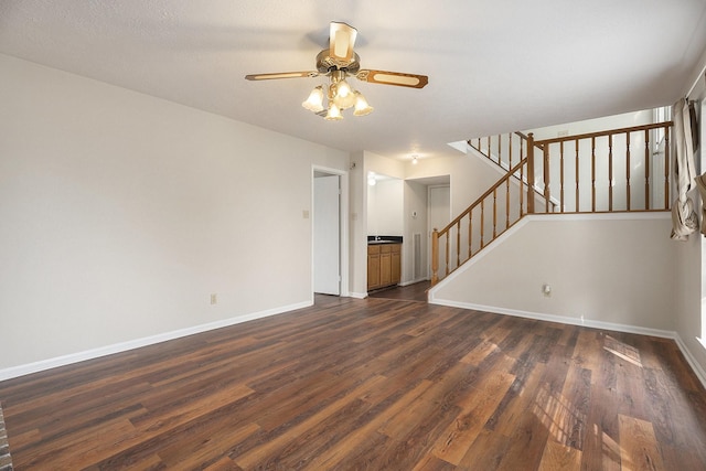 unfurnished living room with ceiling fan and dark wood-type flooring