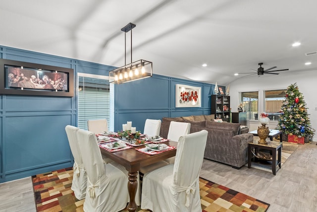 dining area featuring ceiling fan, light hardwood / wood-style flooring, and vaulted ceiling