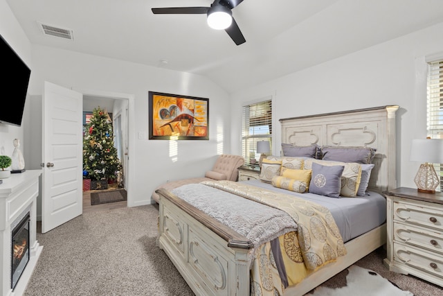 bedroom featuring ceiling fan, light colored carpet, and lofted ceiling