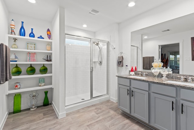 bathroom featuring vanity, hardwood / wood-style flooring, and an enclosed shower