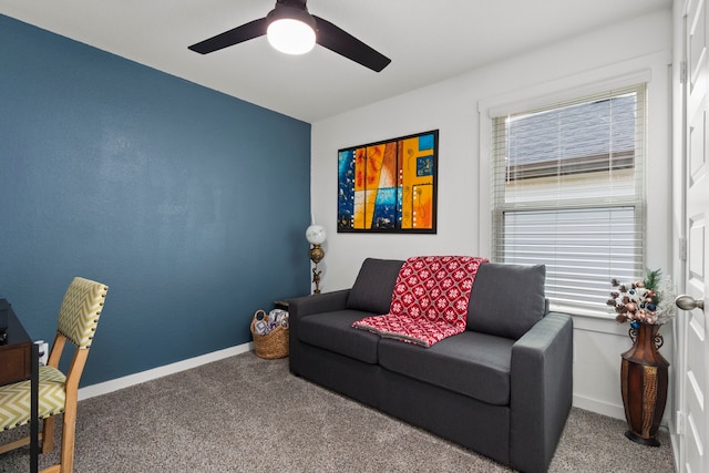 living room featuring carpet flooring, ceiling fan, and a healthy amount of sunlight