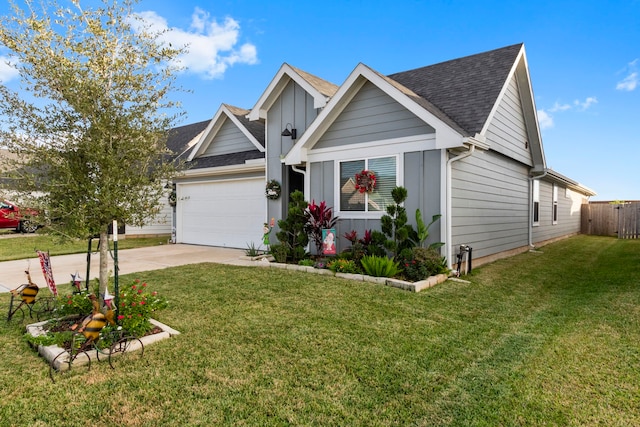 view of front of property featuring a garage and a front yard