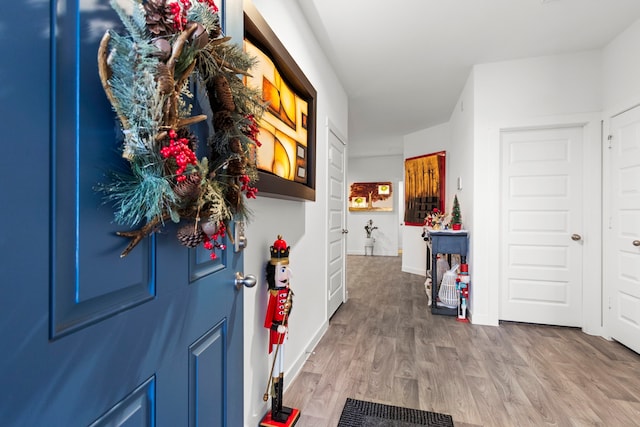 corridor with hardwood / wood-style flooring