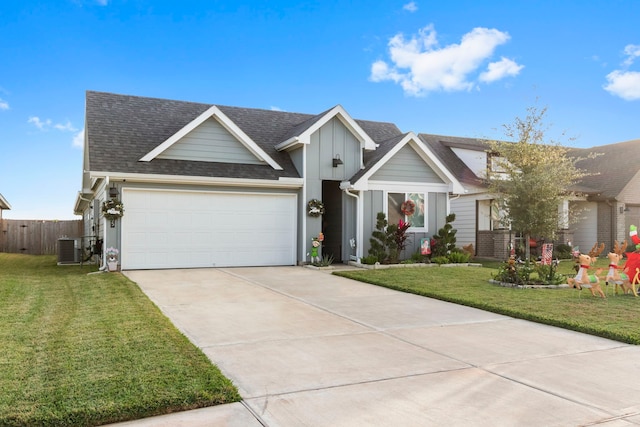 view of front facade with cooling unit, a garage, and a front lawn