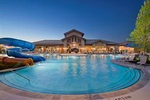 view of swimming pool with a water slide