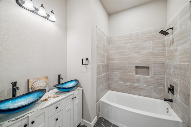 bathroom featuring tile patterned floors, vanity, and tiled shower / bath combo