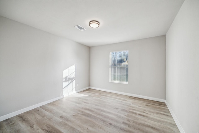 unfurnished room with light wood-type flooring