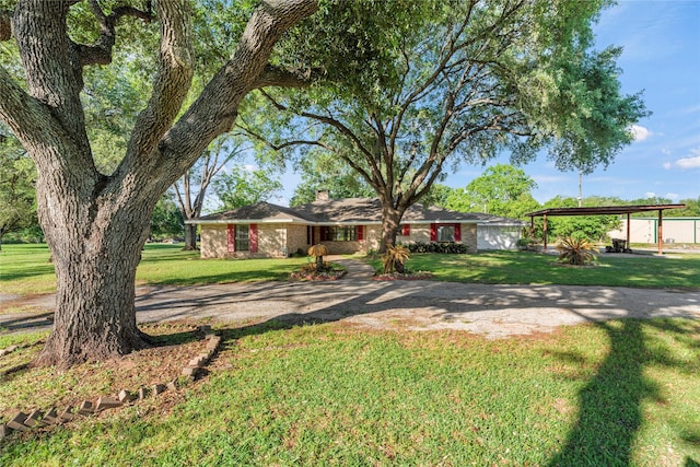 ranch-style house featuring a front yard and a carport