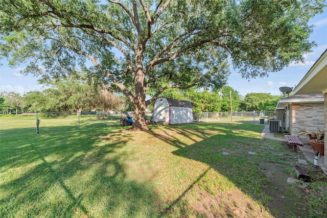 view of yard with a storage shed and central air condition unit