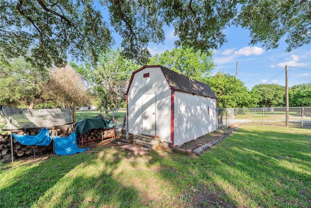 view of outbuilding with a yard