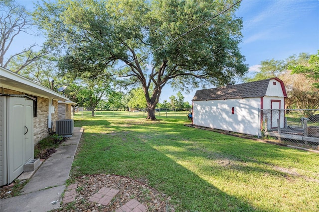 view of yard featuring central AC unit and a shed