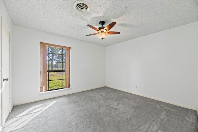 empty room featuring ceiling fan and light colored carpet