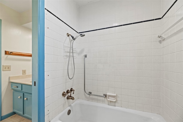 bathroom featuring vanity and tiled shower / bath combo