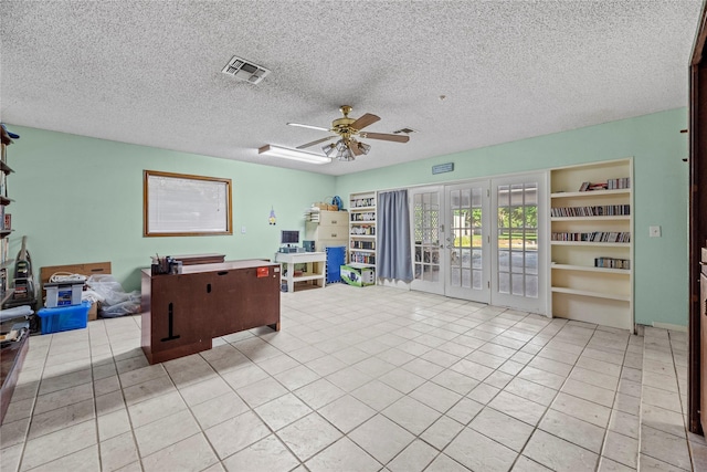 interior space featuring ceiling fan, a textured ceiling, and french doors