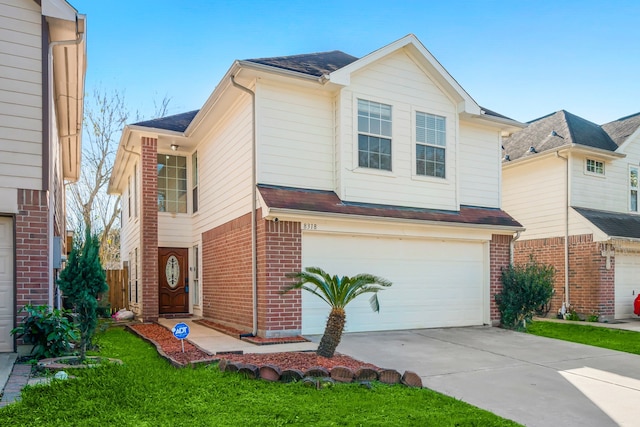 view of front of house with a front yard and a garage