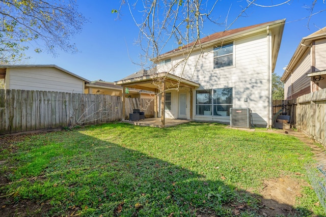 back of house featuring central AC, a patio, a lawn, and a fenced backyard