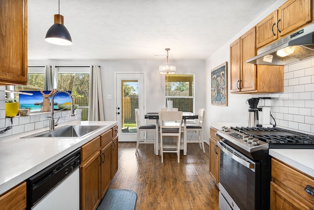 kitchen featuring tasteful backsplash, gas stove, sink, decorative light fixtures, and dishwasher