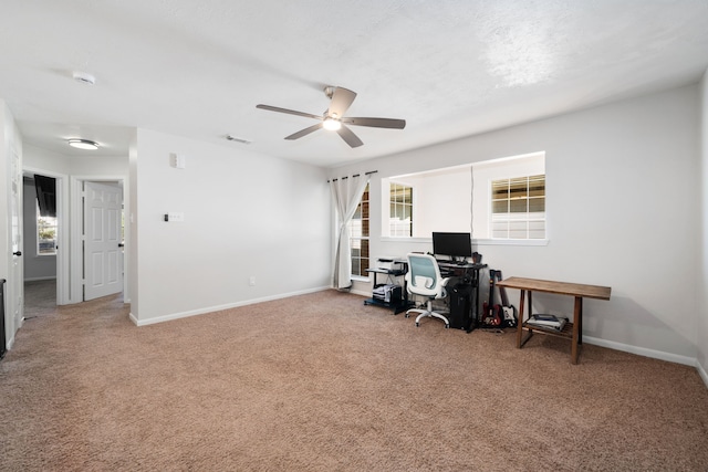 office space featuring ceiling fan, carpet, and a healthy amount of sunlight