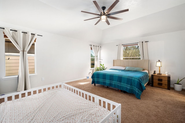 carpeted bedroom featuring vaulted ceiling and ceiling fan