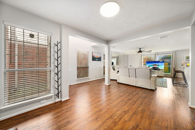 unfurnished living room with hardwood / wood-style floors and ceiling fan