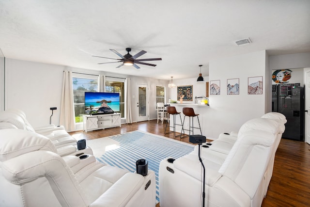 living room featuring dark hardwood / wood-style flooring and ceiling fan